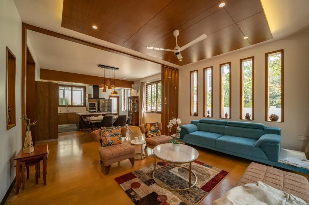 Modern Living Room with Brown Leather Sofa and Wooden Stools